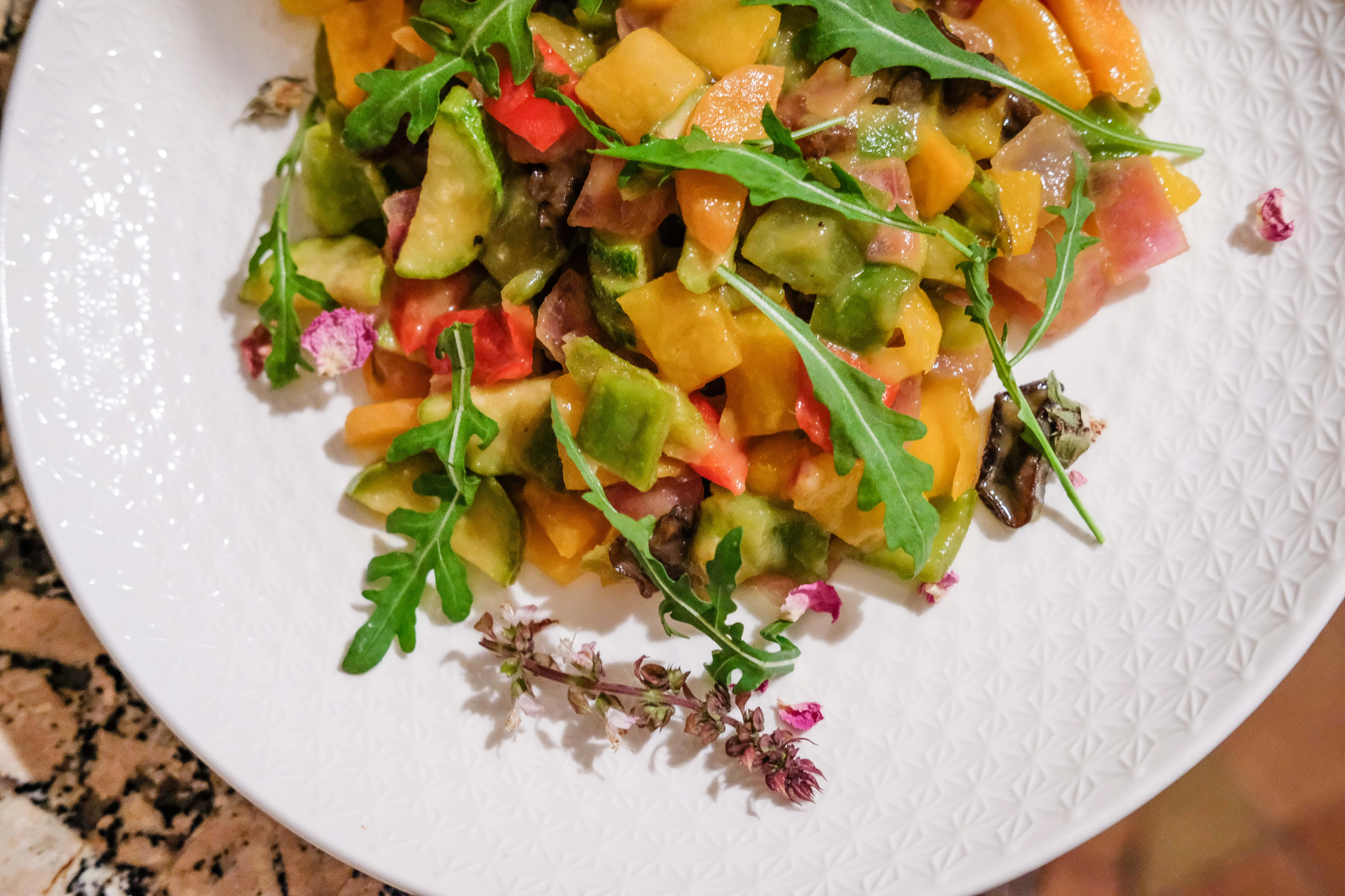 White ceramic dish with sautéed vegetables.